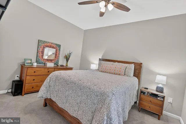 a bedroom with a bed and lamp