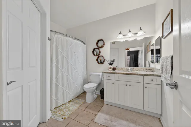 a spacious bathroom with a double vanity sink mirror and toilet