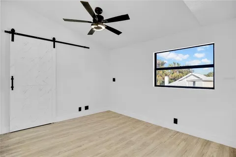 a view of empty room with wooden floor