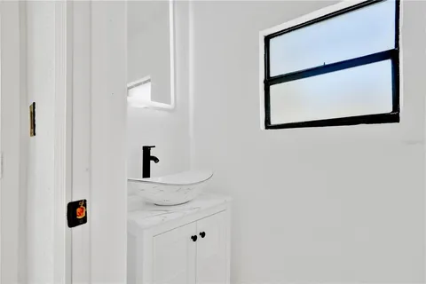 a bathroom with a sink and mirror