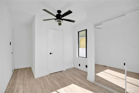 a view of a livingroom with a hardwood floor and a ceiling fan