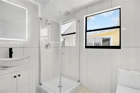 a bathroom with a shower and a mirror