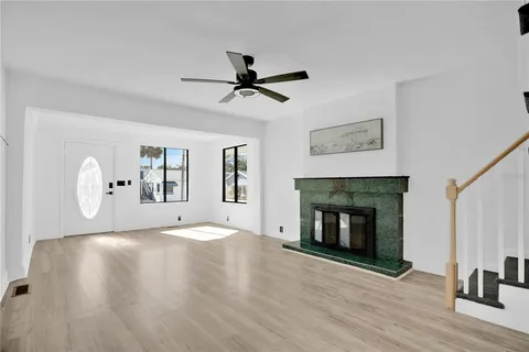 a view of empty room with fireplace and wooden floor