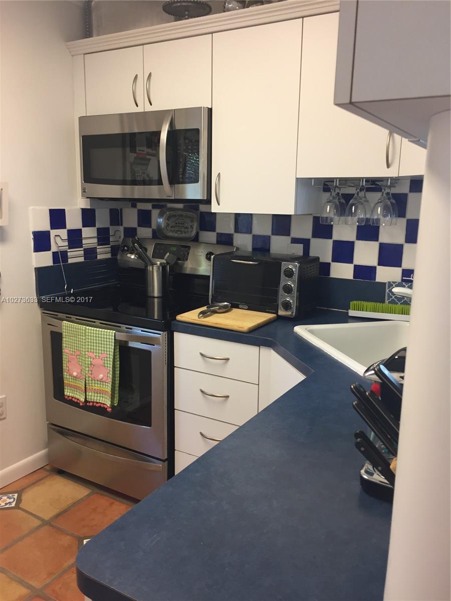5886 Southwest 42nd Street Miami, FL 33155 - Photo 5 of 15 a kitchen with a stove and a microwave