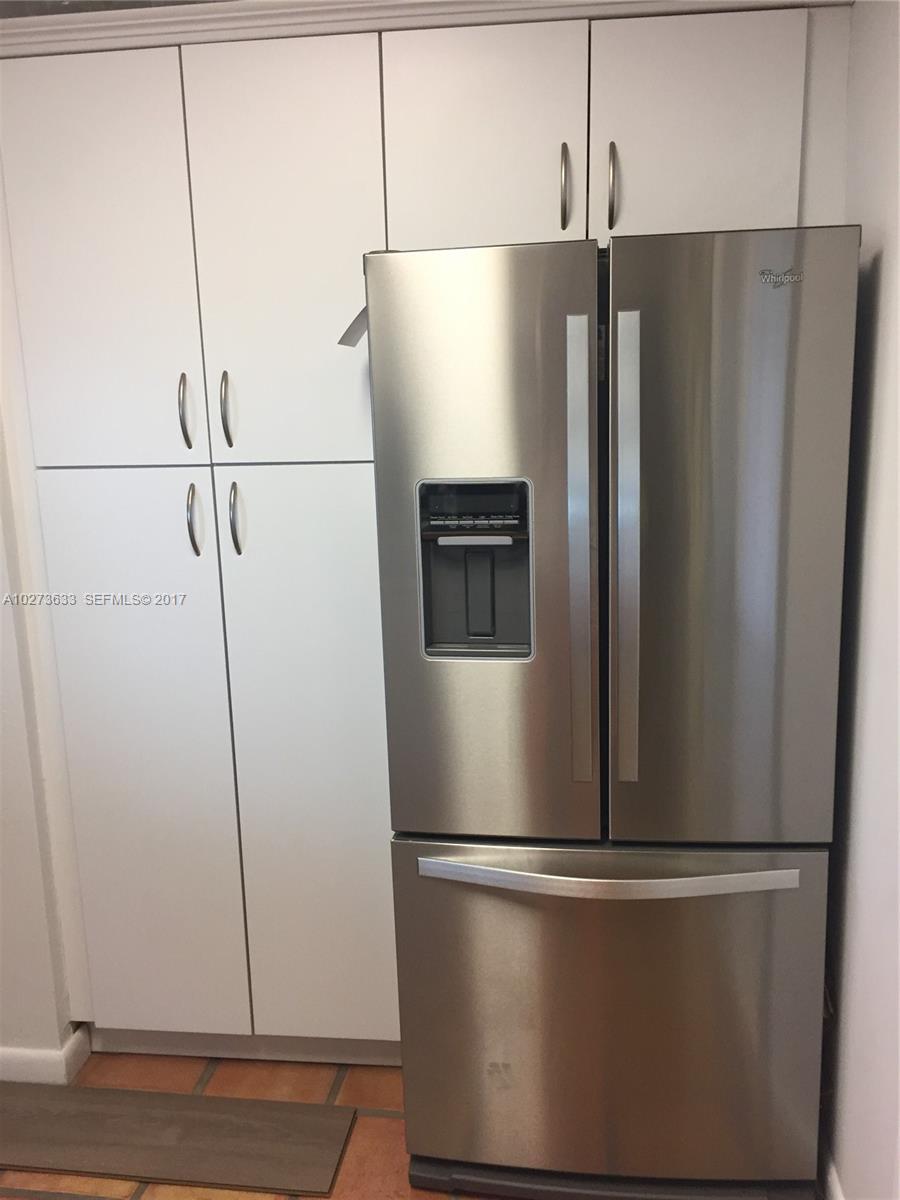 5886 Southwest 42nd Street Miami, FL 33155 - Photo 6 of 15 a metallic refrigerator freezer sitting in a kitchen