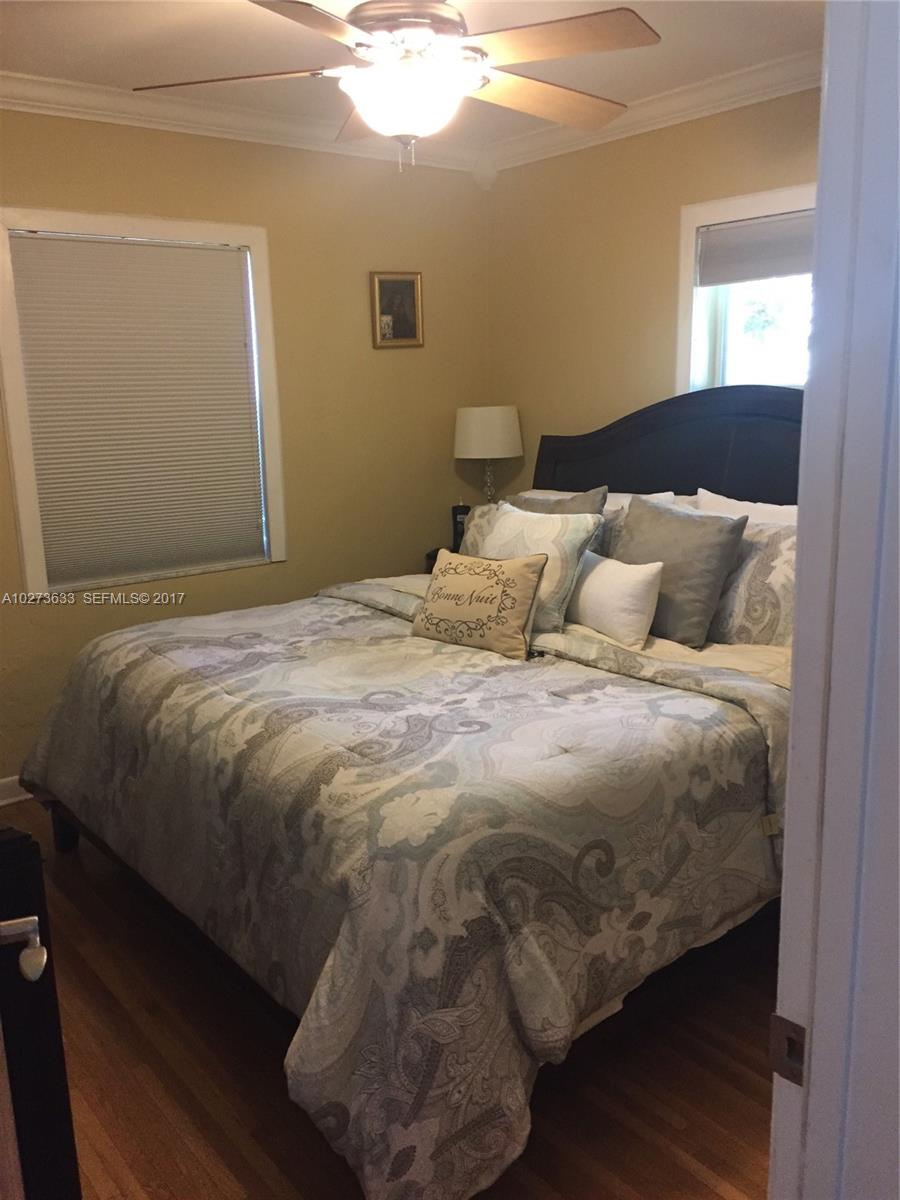 5886 Southwest 42nd Street Miami, FL 33155 - Photo 9 of 15 a bedroom with a bed and window
