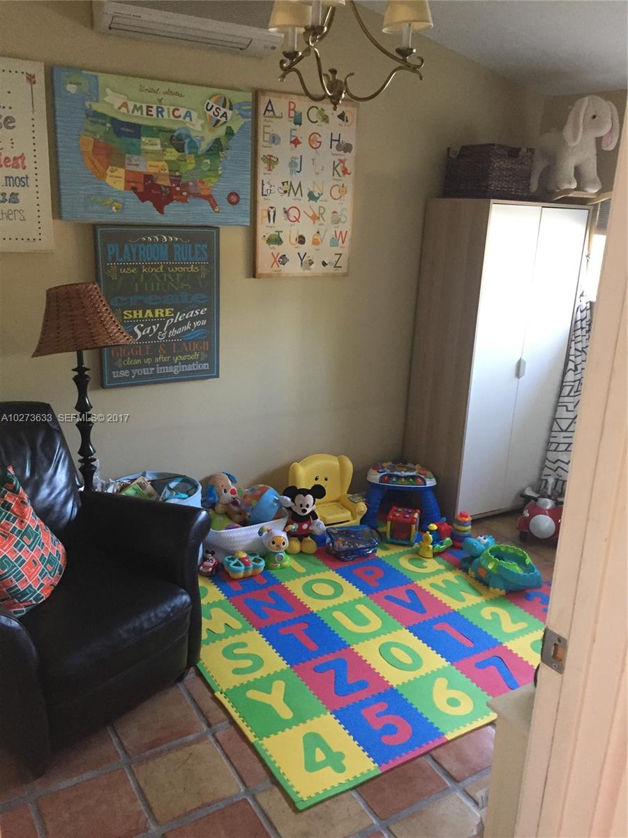 5886 Southwest 42nd Street Miami, FL 33155 - Photo 10 of 15 a room that has a bed and a table in it