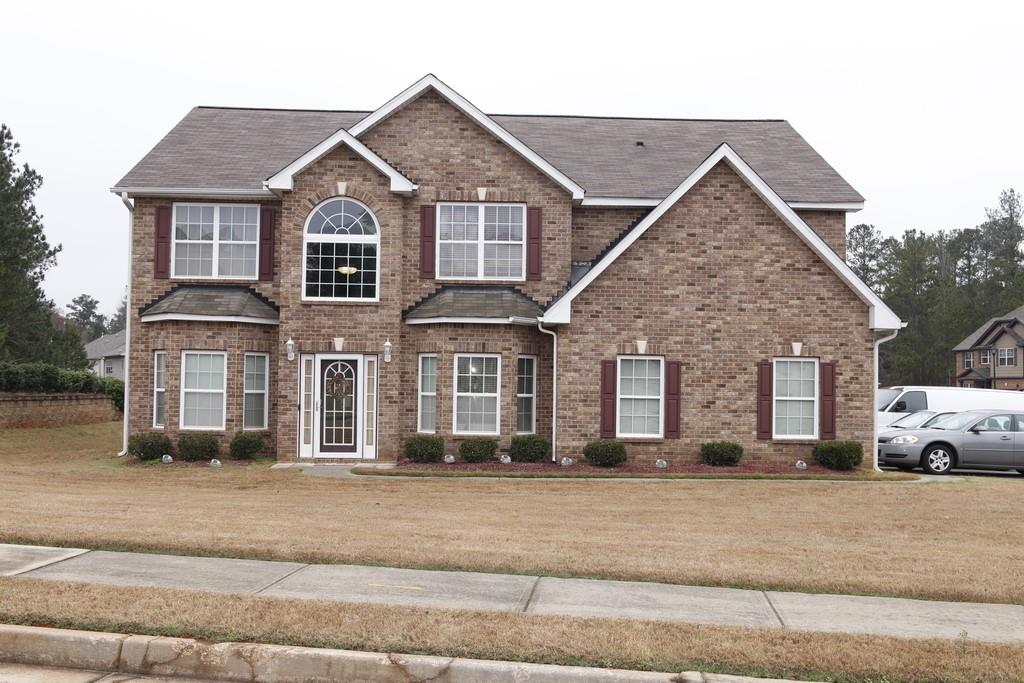 a front view of a house with a yard