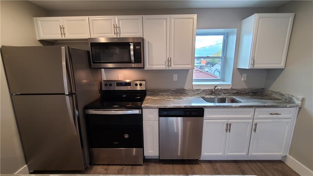 1331 Freeport Road Cheswick, PA 15024 - Photo 6 of 32 a kitchen with stainless steel appliances granite countertop a stove a refrigerator and a microwave