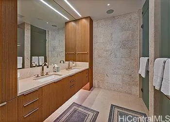 a bathroom with a double vanity sink a toilet and shower
