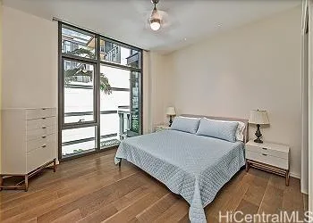 a bedroom with a large bed and a window