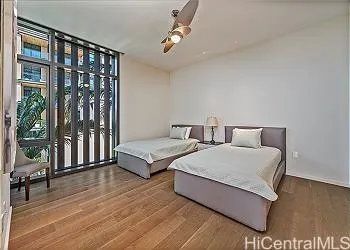 a spacious bedroom with two beds and a large window
