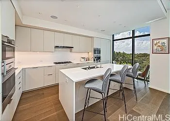a kitchen with a dining table chairs refrigerator and cabinets