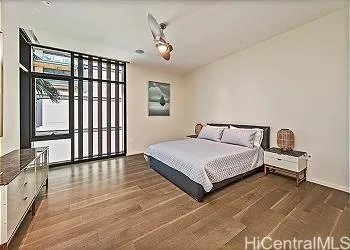 a bedroom with a bed and a large window