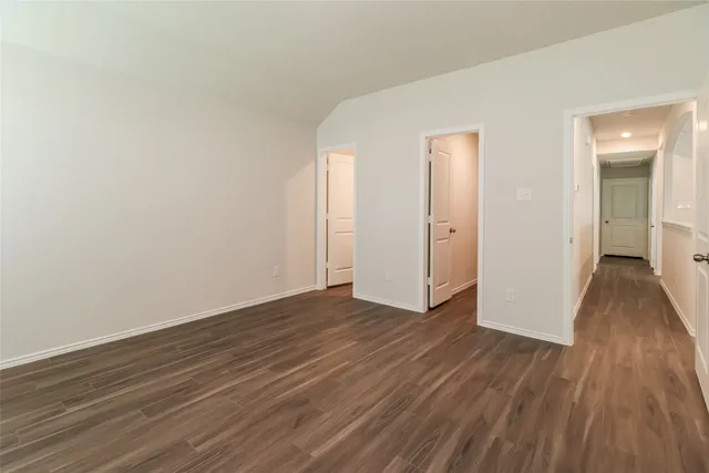 a view of a room with wooden floor and doors