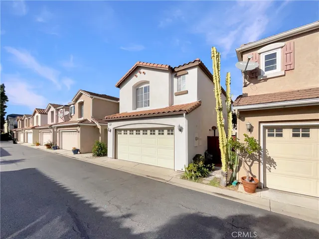 a view of a white house with a street