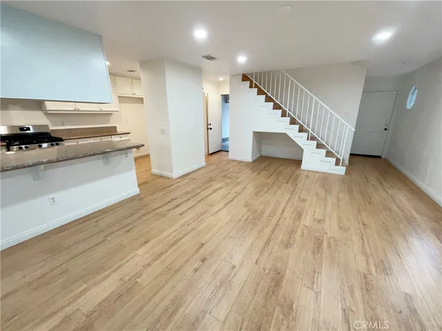 a view of kitchen with wooden floor and electronic appliances