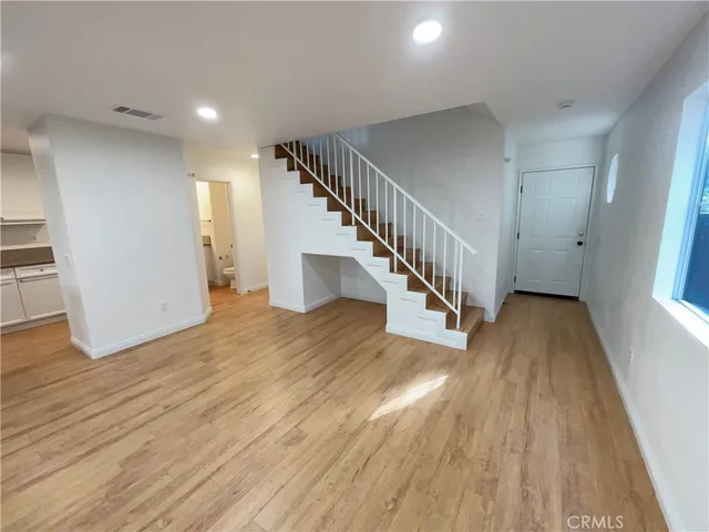 a view of entryway and hall with wooden floor