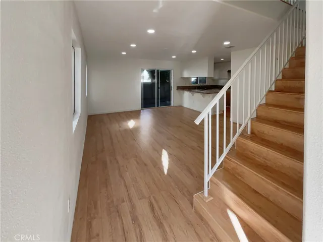 a view of entryway and hall with wooden floor