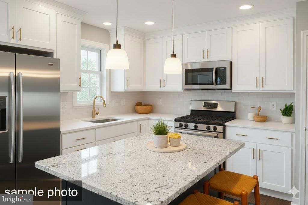 13 Castle Drive Robesonia, PA 19551 - Photo 12 of 22 a kitchen with stainless steel appliances granite countertop a sink a stove and a refrigerator