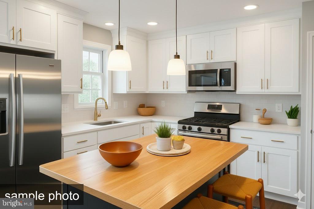 13 Castle Drive Robesonia, PA 19551 - Photo 14 of 22 a kitchen with a sink a stove and chairs