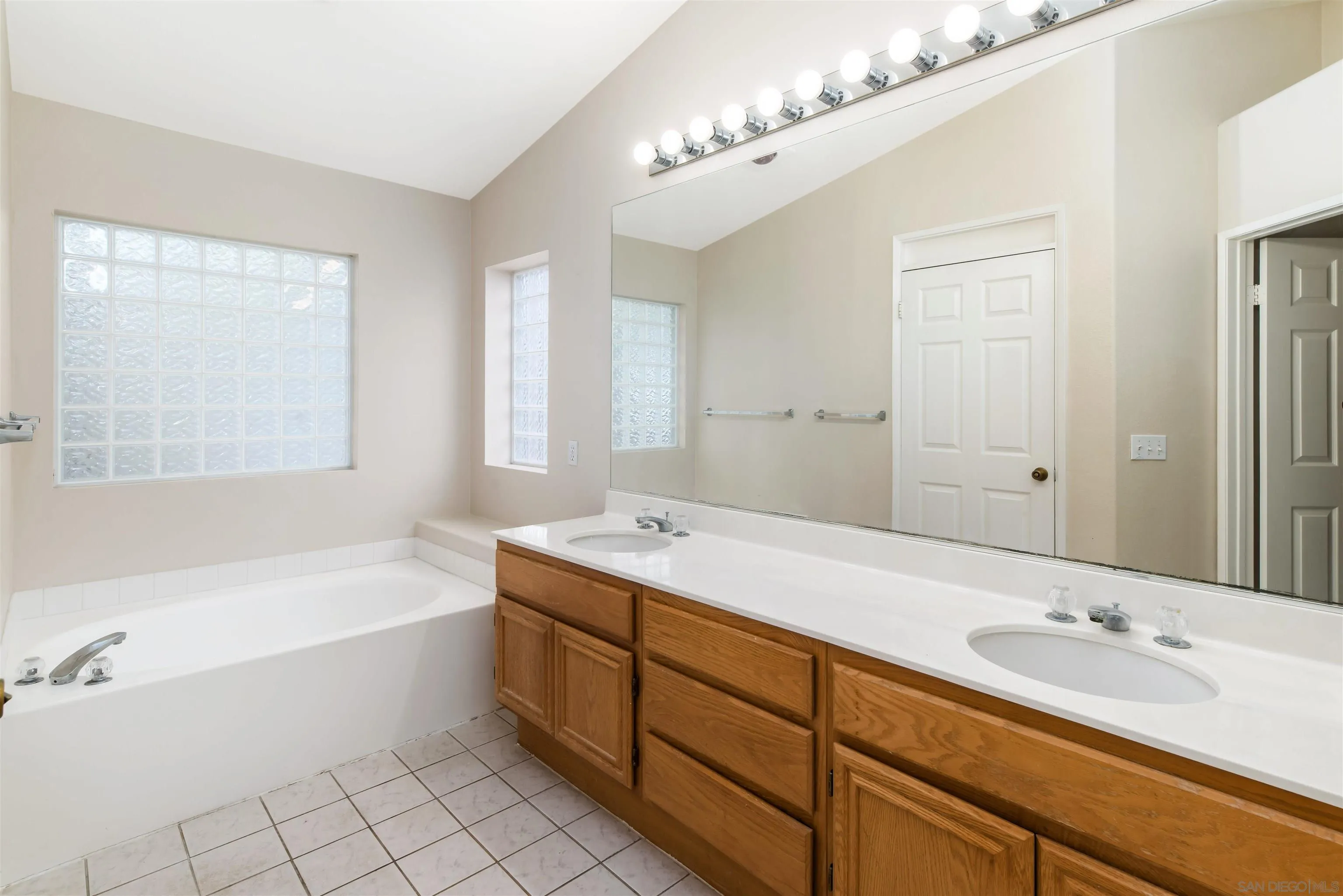 2002 Snapdragon Lane Alpine, CA 91901 - Photo 15 of 25 a bathroom with a sink double vanity granite tub shower and a mirror