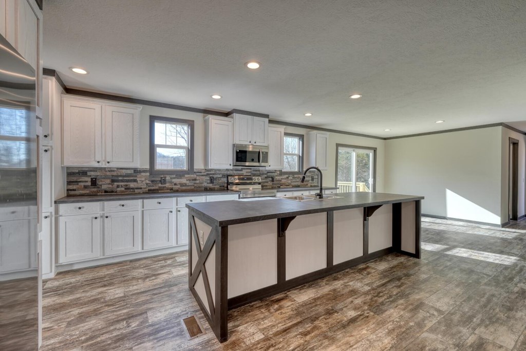 2045 Upper Bell Creek Road Hiawassee, GA 30546 - Photo 14 of 47 a kitchen with granite countertop a stove a sink and a refrigerator
