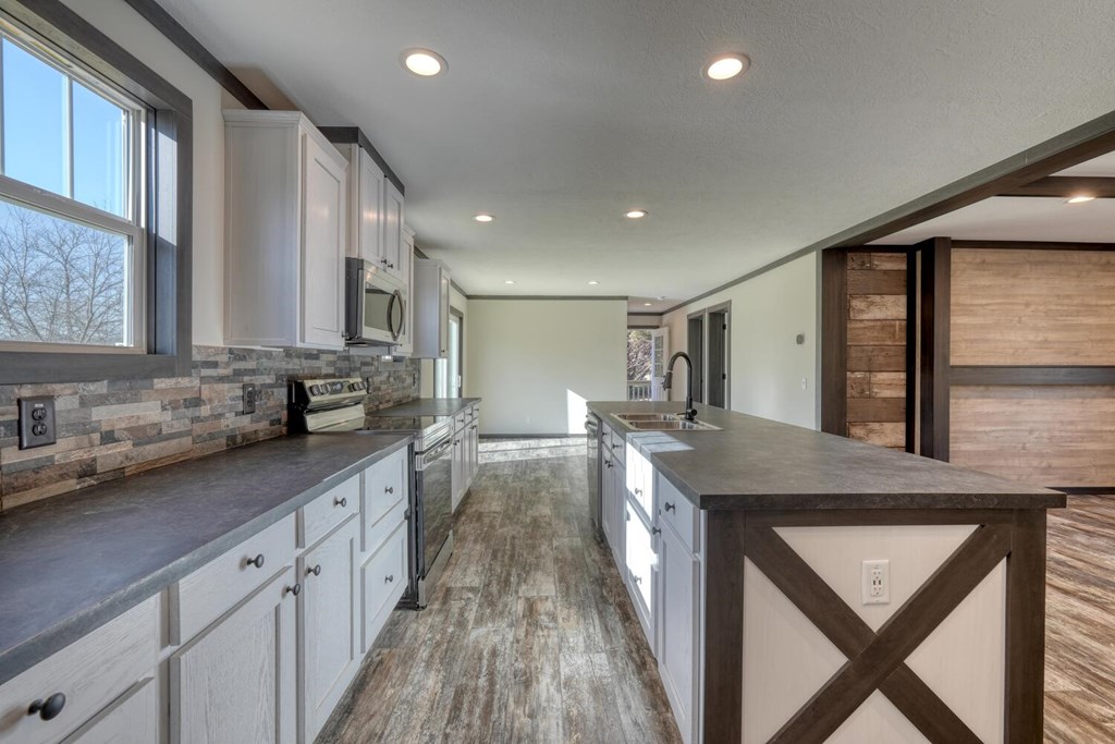 2045 Upper Bell Creek Road Hiawassee, GA 30546 - Photo 15 of 47 a kitchen with sink stove and cabinets