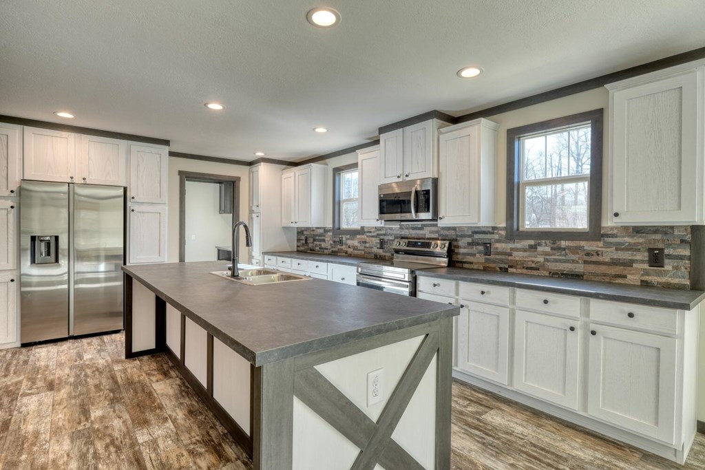 2045 Upper Bell Creek Road Hiawassee, GA 30546 - Photo 18 of 47 a kitchen with stainless steel appliances granite countertop a sink stove and refrigerator