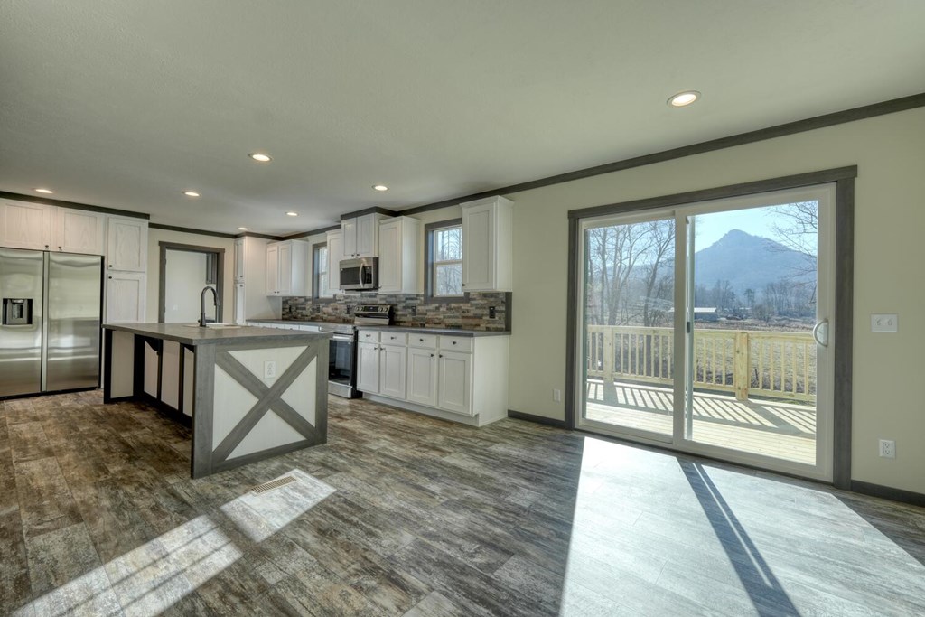 2045 Upper Bell Creek Road Hiawassee, GA 30546 - Photo 19 of 47 a open kitchen with stainless steel appliances granite countertop a refrigerator stove top oven and sink