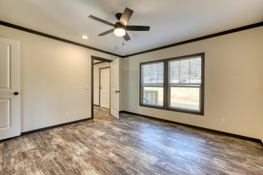 2045 Upper Bell Creek Road Hiawassee, GA 30546 - Photo 24 of 47 an empty room with wooden floor fan and windows
