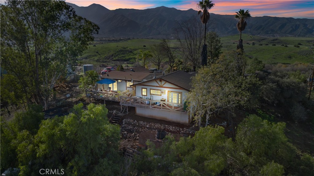 a view of a house with a yard and a street