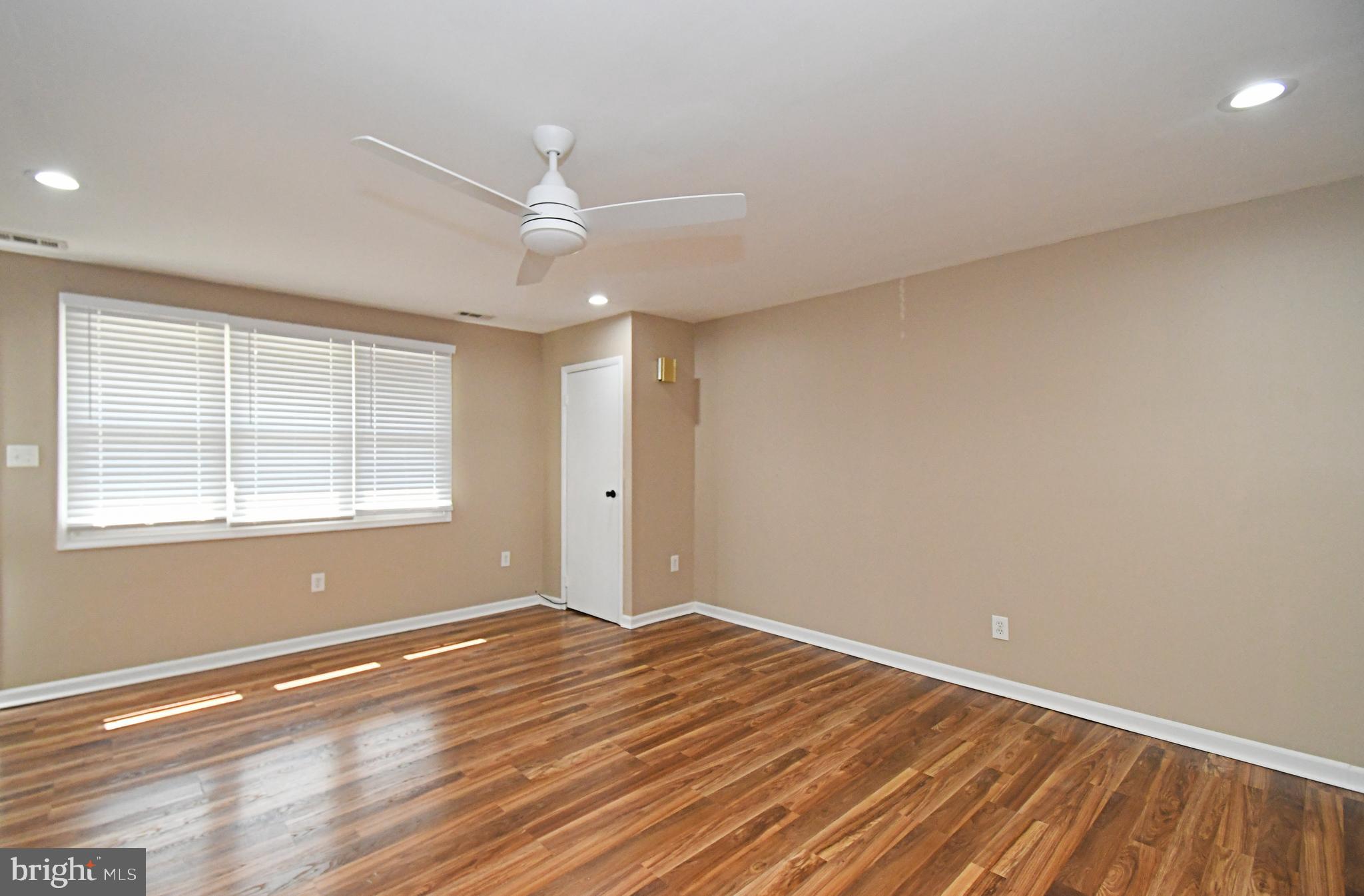 12134 Rambler Road Philadelphia, PA 19154 - Photo 8 of 40 an empty room with wooden floor and windows