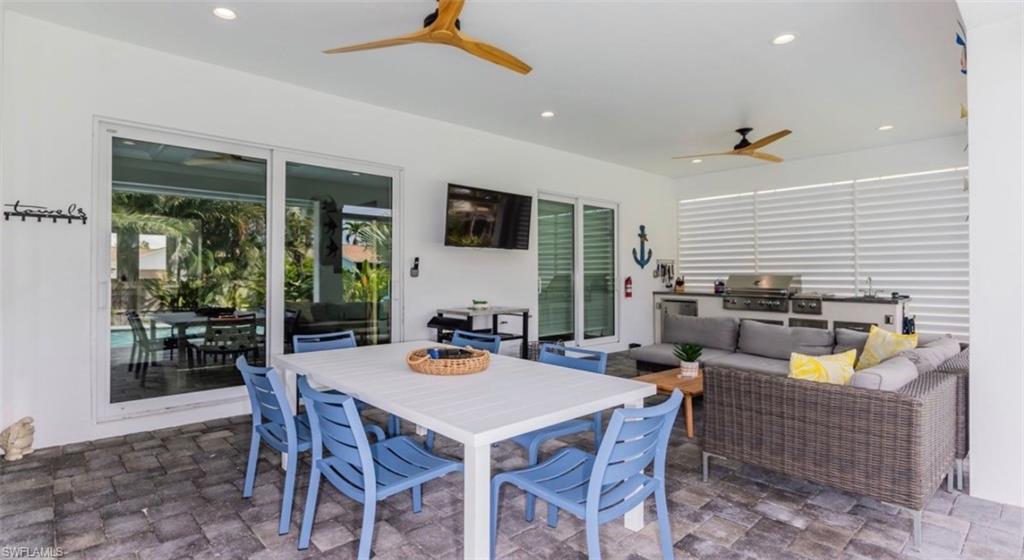 118 Bermuda Road Marco Island, FL 34145 - Photo 14 of 16 a view of a dining room and livingroom with furniture wooden floor and a rug