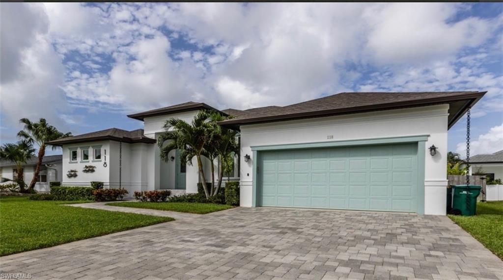 118 Bermuda Road Marco Island, FL 34145 - Photo 2 of 16 a house with a yard and a large parking space