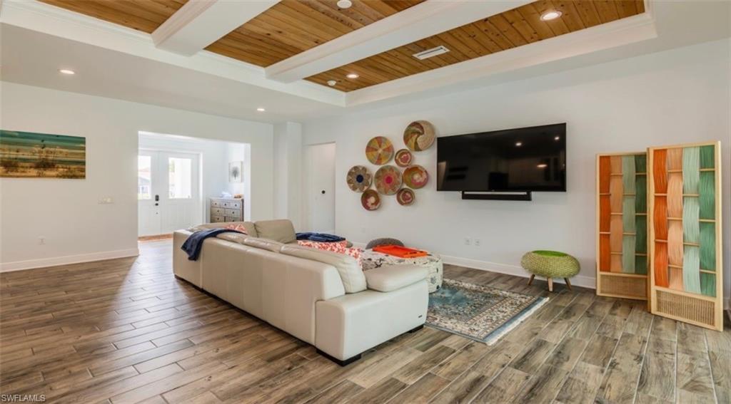 118 Bermuda Road Marco Island, FL 34145 - Photo 4 of 16 a living room with furniture and a flat screen tv