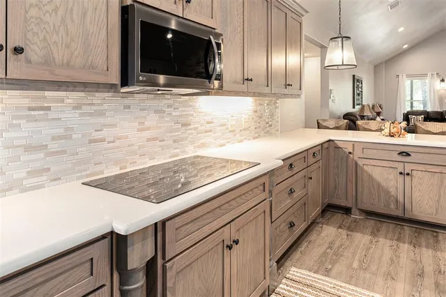 a kitchen with stainless steel appliances granite countertop a sink and a stove