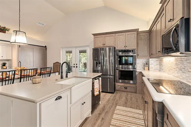a kitchen with stainless steel appliances granite countertop a sink stove and refrigerator