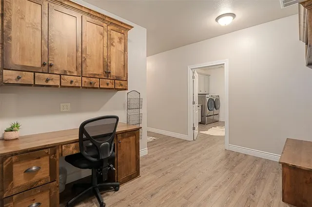a view of a workspace with furniture and a window