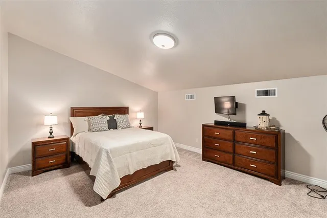 a bedroom with a bed and a television