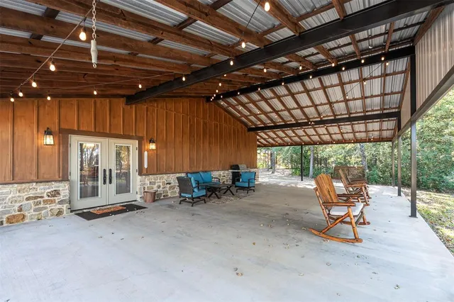 a view of a patio with table and chairs with wooden floor