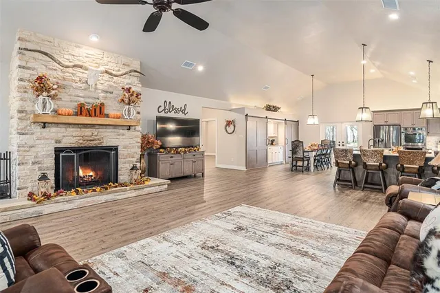 a living room with furniture kitchen view and a fireplace