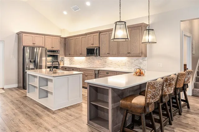 a kitchen with a sink cabinets and wooden floor