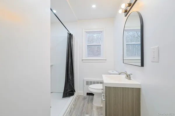 a bathroom with a sink a toilet and a mirror