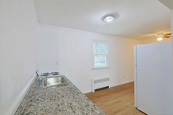 a view of a livingroom with wooden floor and a rug