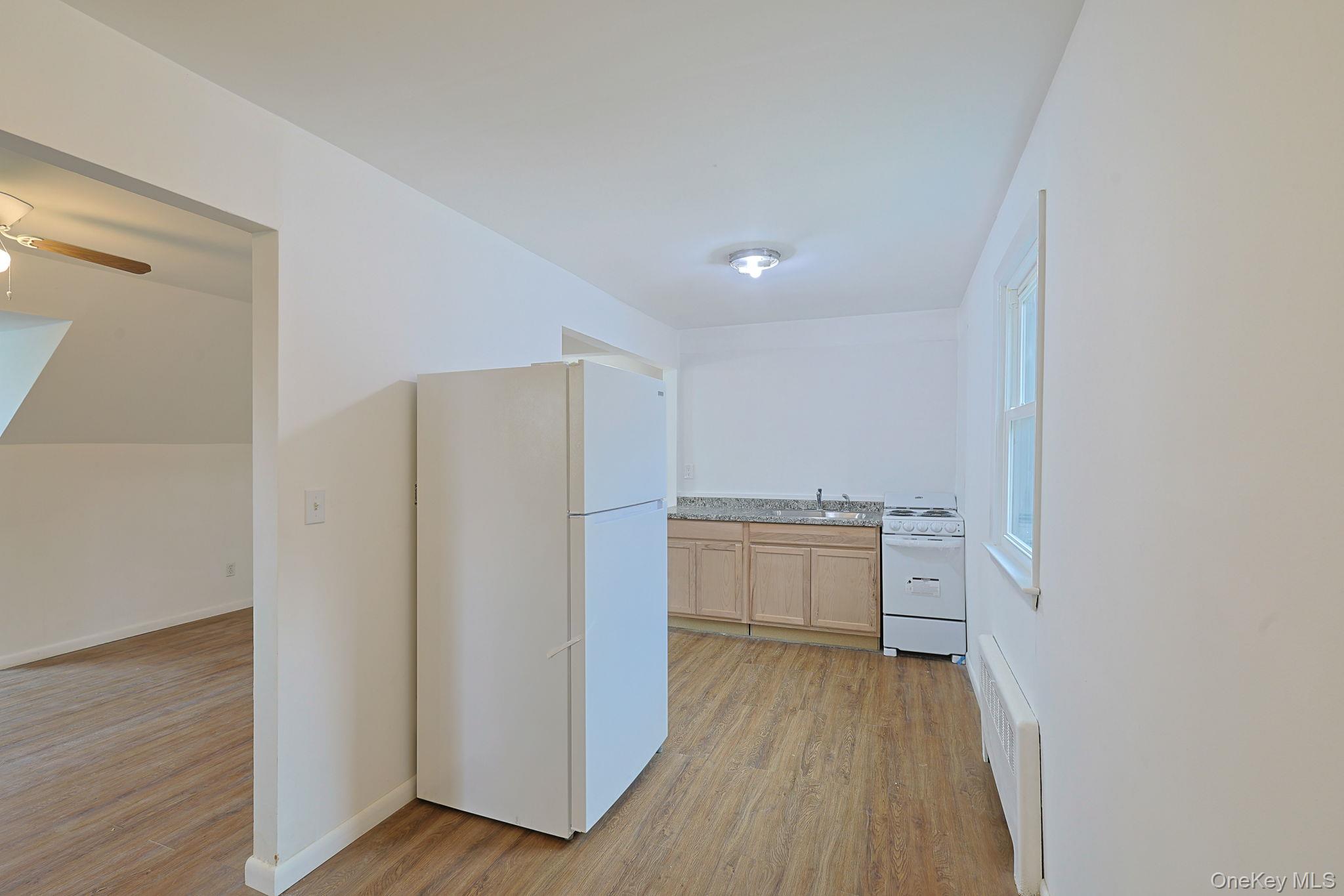 34 Old Bedford Road Goldens Bridge, NY 10526 - Photo 28 of 38 a view of a kitchen with a sink and dishwasher a refrigerator with wooden floor