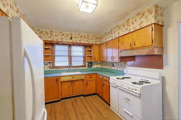 a kitchen with a stove a sink and a refrigerator
