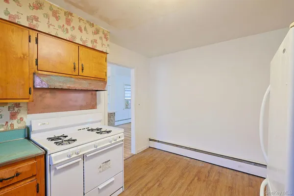 a kitchen with a stove a sink and a window