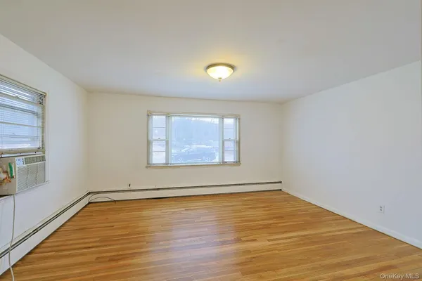a view of a room with wooden floor and window in a room