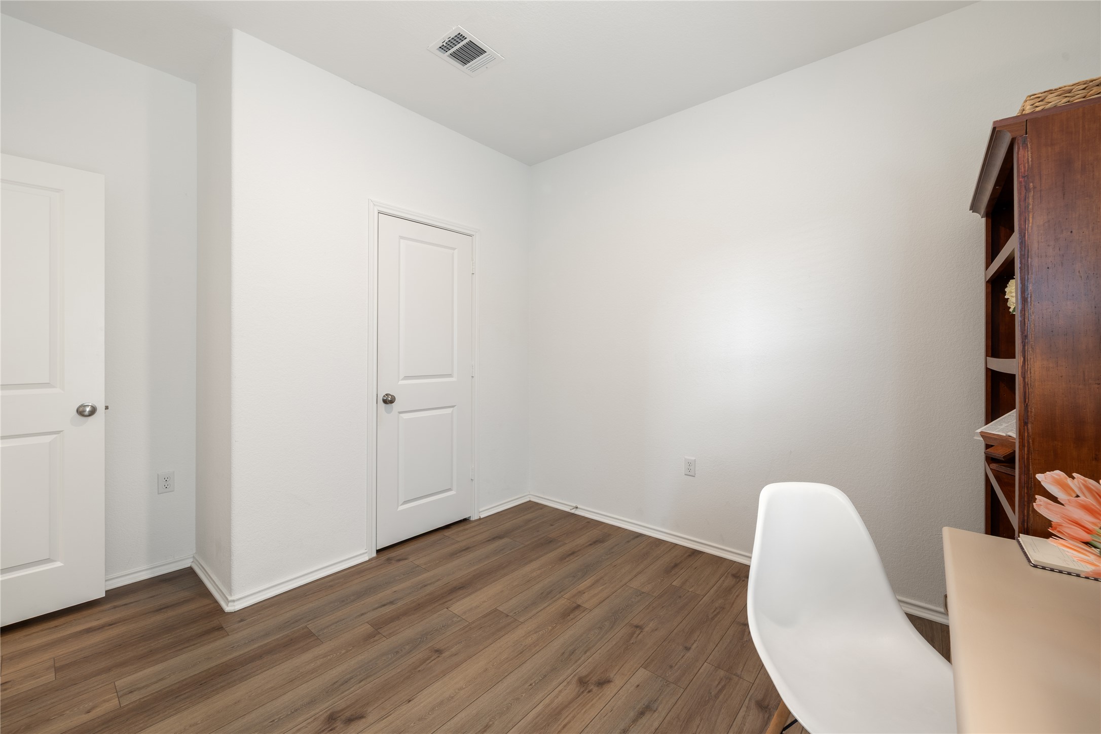 14404 Berning Road Manor, TX 78653 - Photo 29 of 38 Hardwood-style flooring and pristine walls create an inviting space, ideal for an office or study.